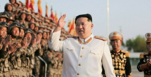 Kim Jong Un celebrates successful military parade with dozens of group photos